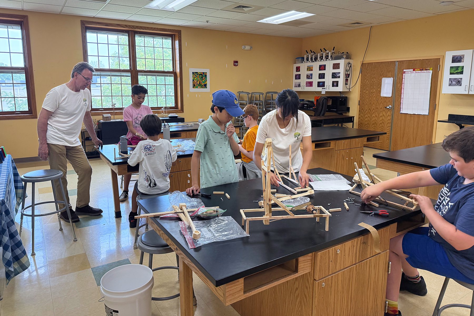 Guest speaker Linas Sutkus leans in to help a team build their catapult